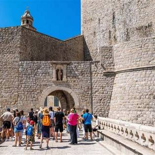 Stone gate and visitors on Dubrovnik City Walls